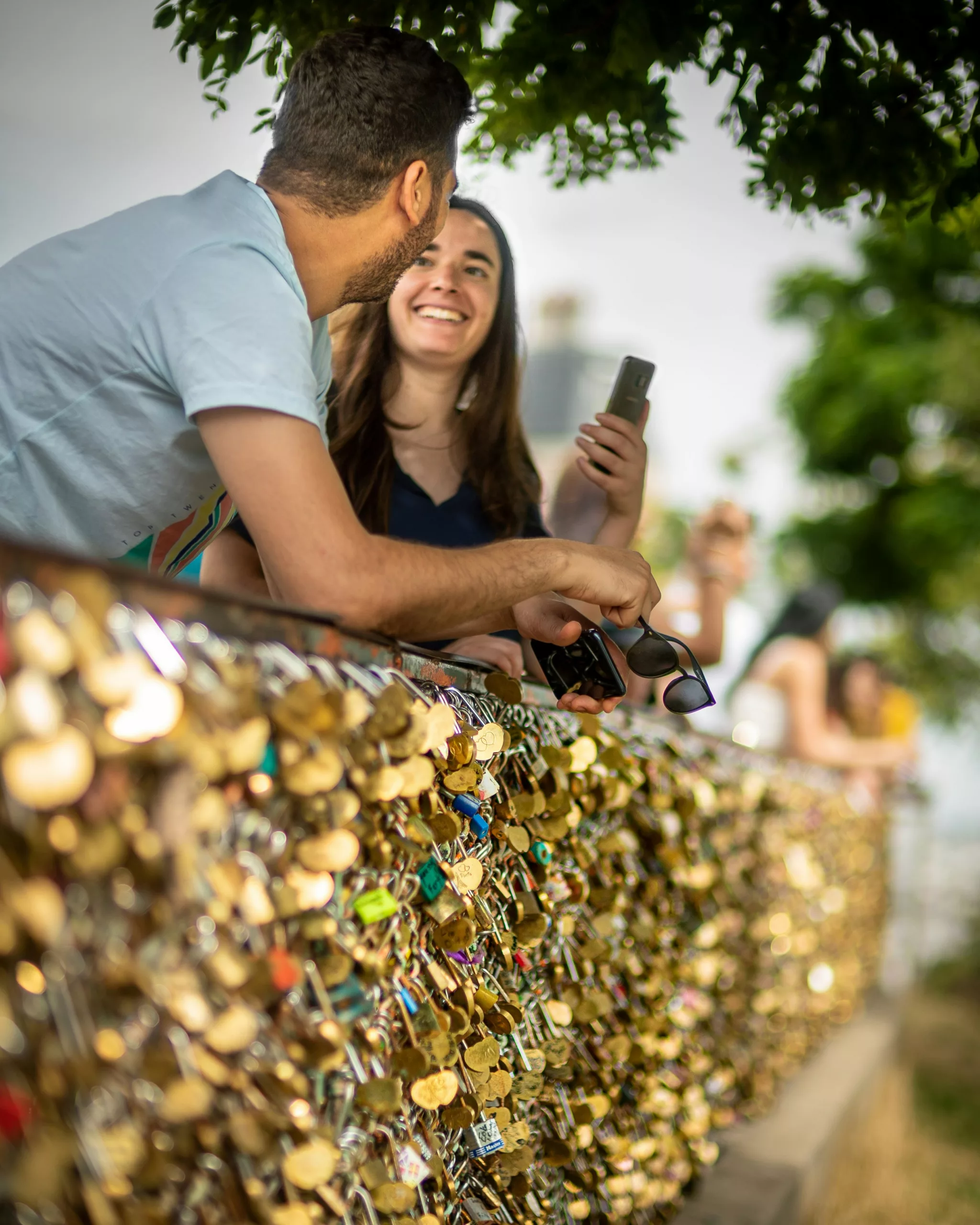 Happy tourist couple unlocking a smart lock on a door in Valence city center