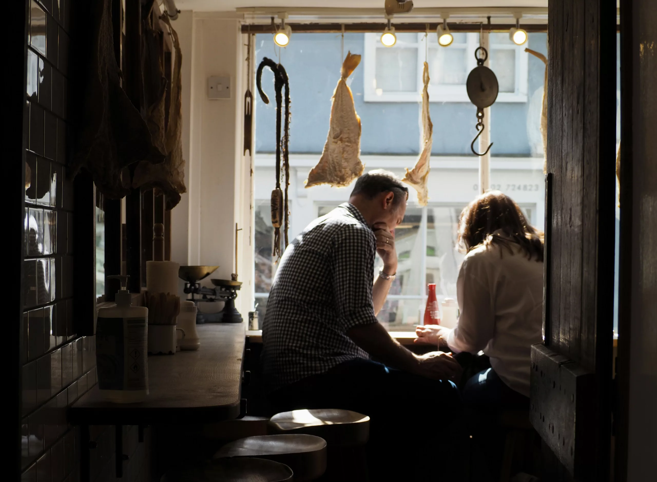 A relaxed couple looking at a tablet in a stylish kitchen, smiling, reviewing their rental income growth graph
