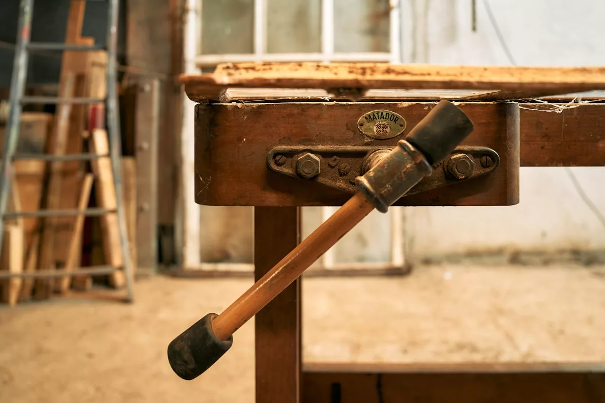 A hammer is stuck into a piece of wood