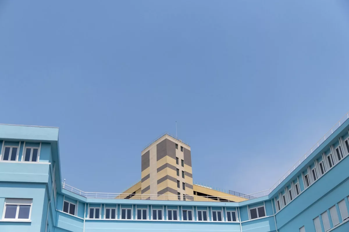 a blue building with a yellow building in the background