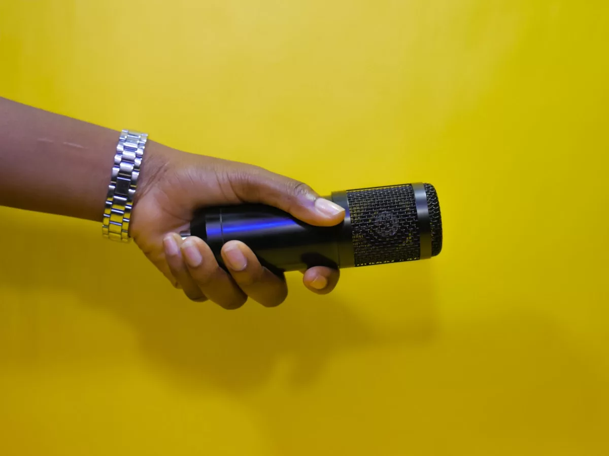 a hand holding a black object