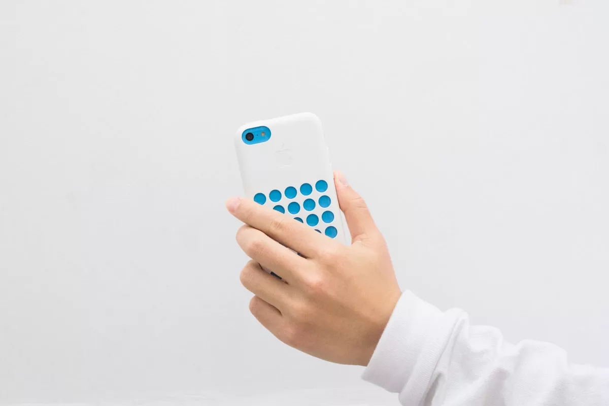 a person holding a small blue device