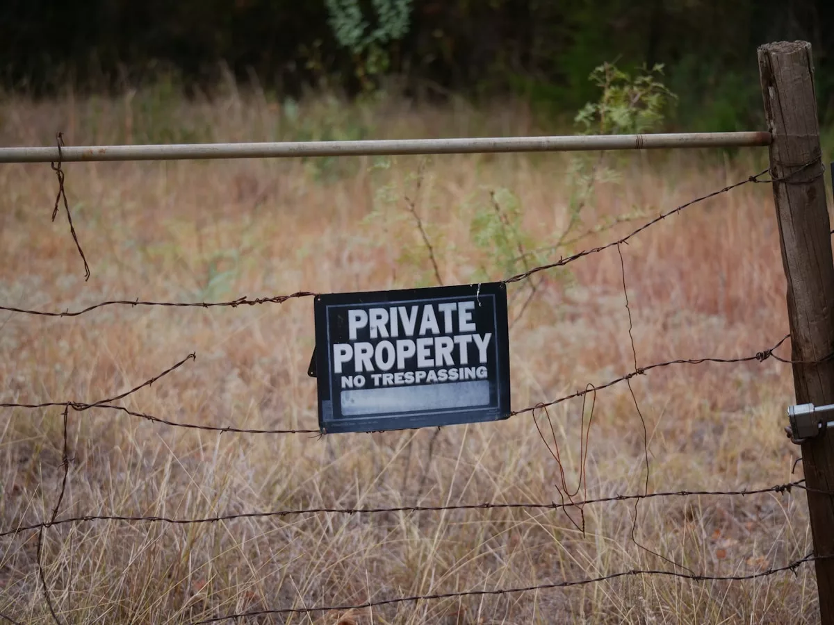 A private property sign is posted on a fence