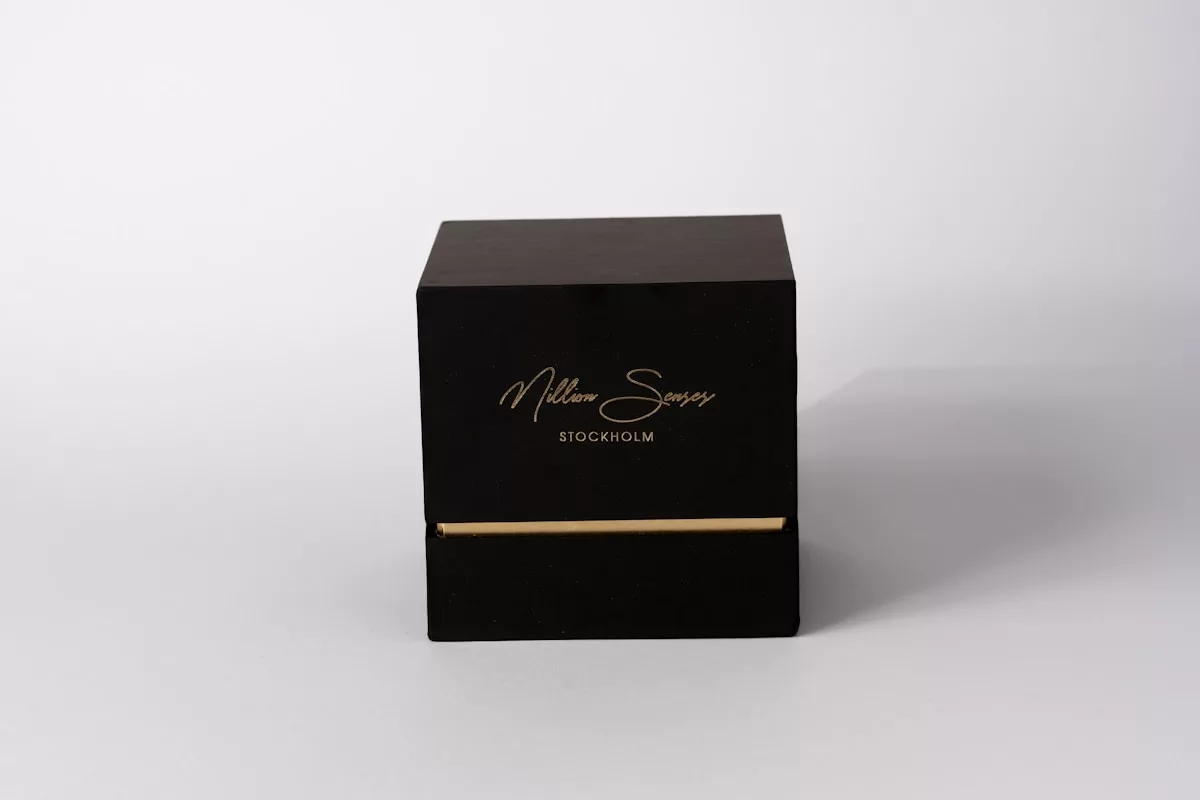 A black box with gold lettering on white background