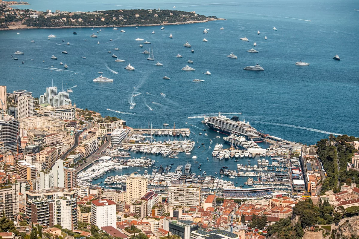 Monaco's harbor is filled with boats and buildings.