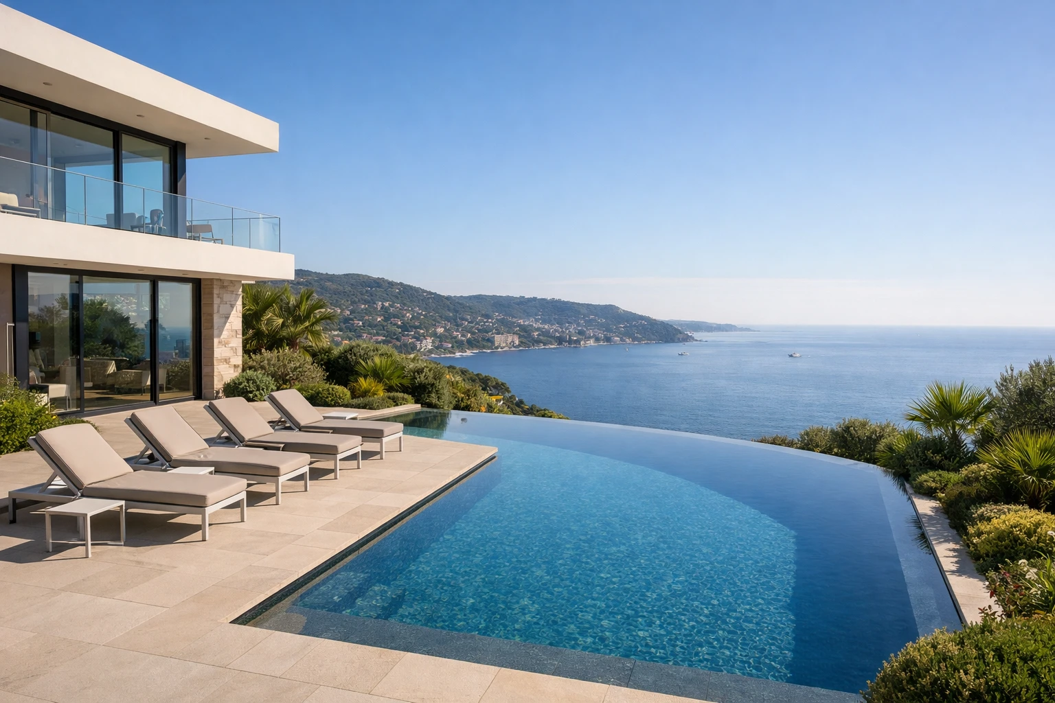 Modern luxury villa overlooking azure Mediterranean coastline on French Riviera, pristine infinity pool reflecting blue sky, elegant terrace with lounge chairs, lush green gardens, upscale vacation rental property management showcase, professional photography style with warm natural lighting