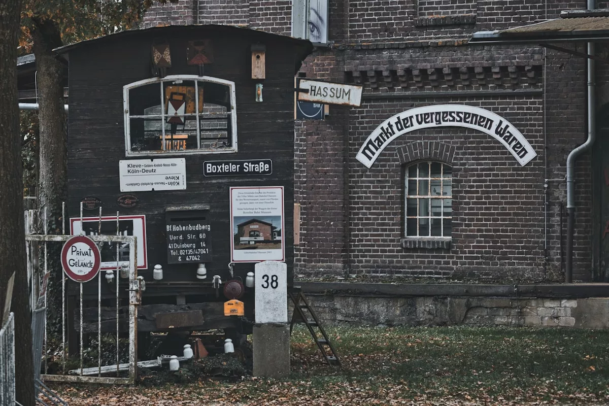 Old brick building with a small dark trailer.