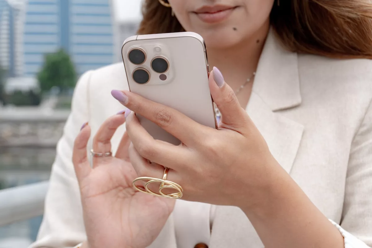 A woman holds a phone, likely taking a photo.