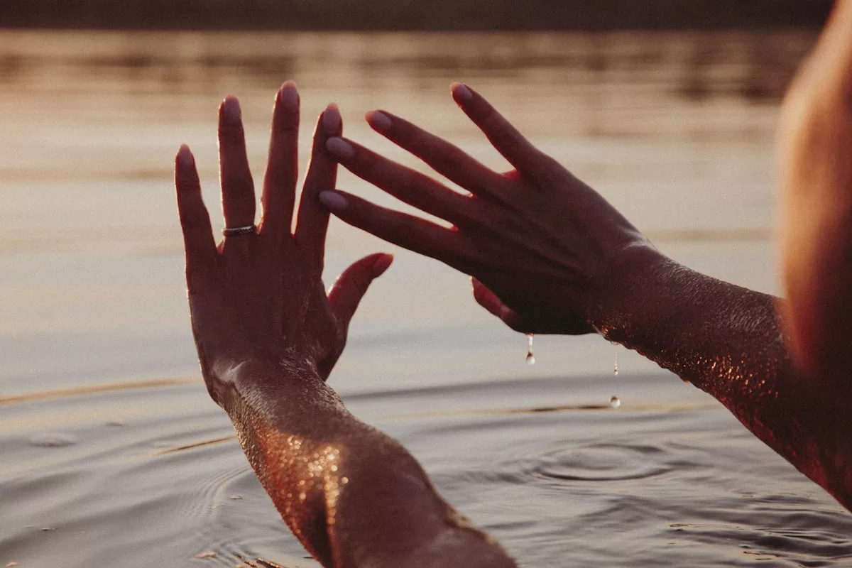 persons hand on water