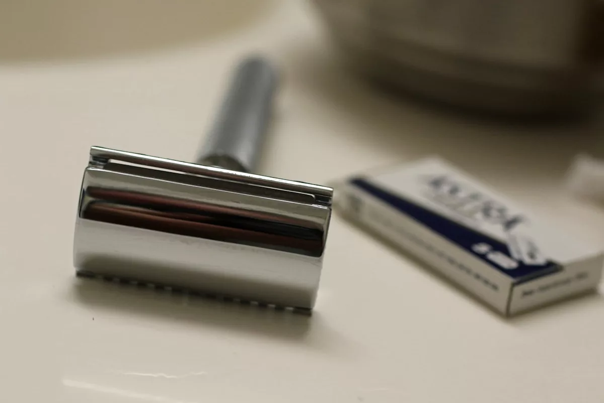 Chrome safety razor and blade box on counter