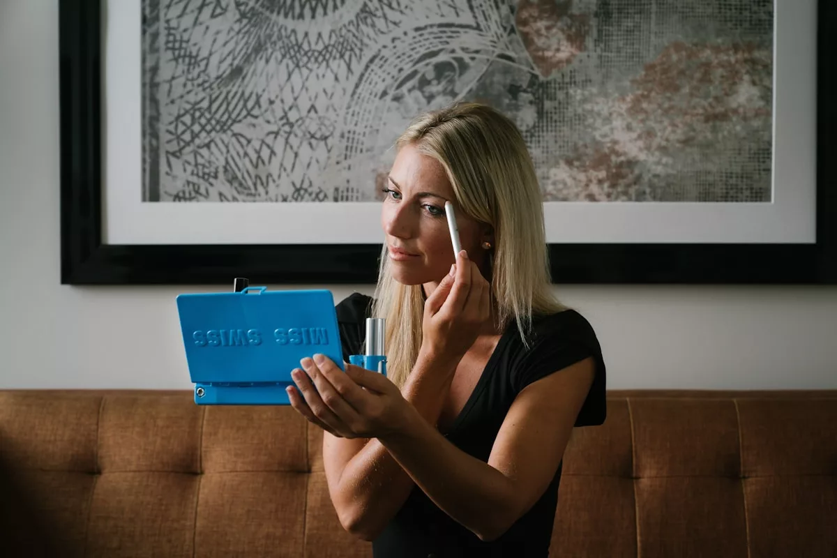 woman in black shirt holding blue box