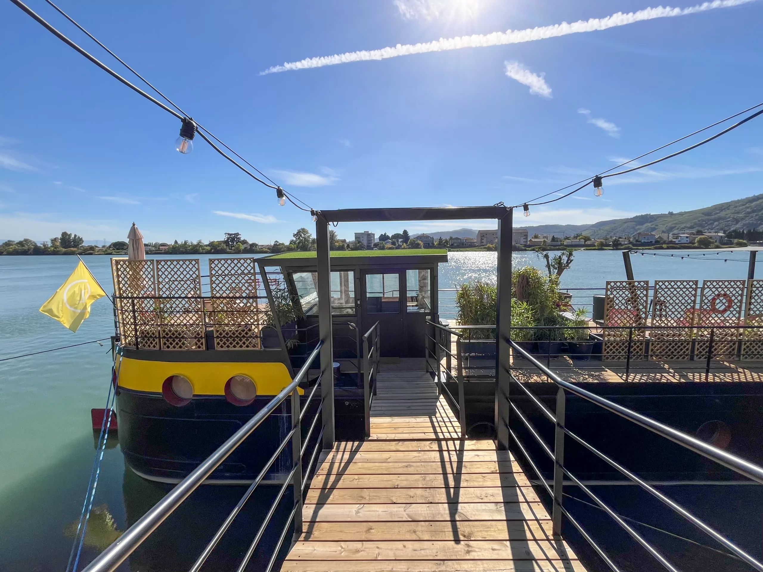 Terrasse aménagée au bord du Rhône, avec salon de jardin