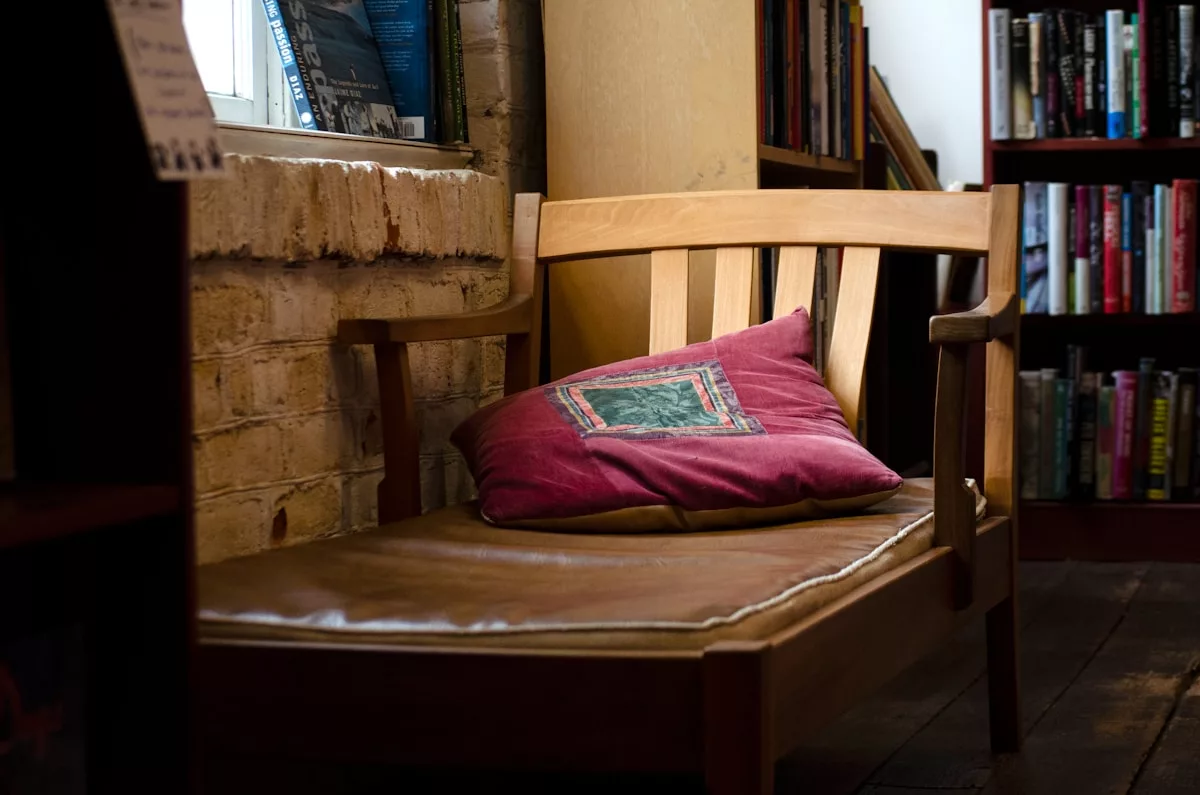 a wooden chair with a pillow on top of it